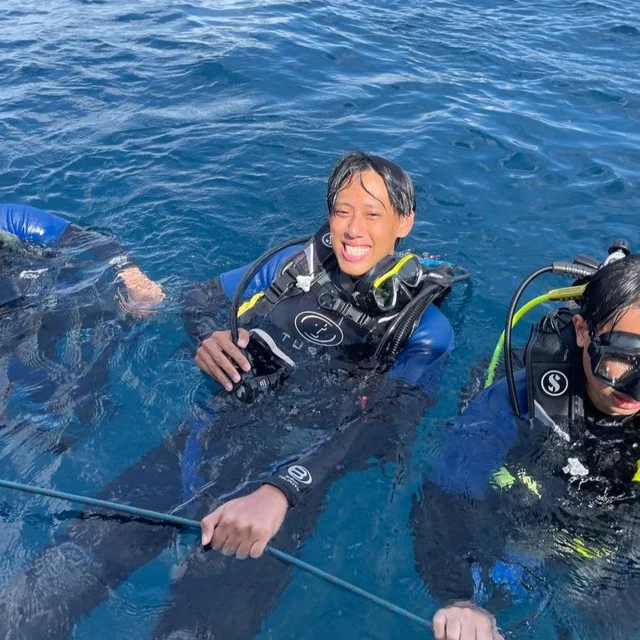 Shyan-Yong in scuba gear, smiling at the water's surface.